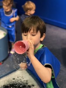 boy blowing bubbles boston children's museum