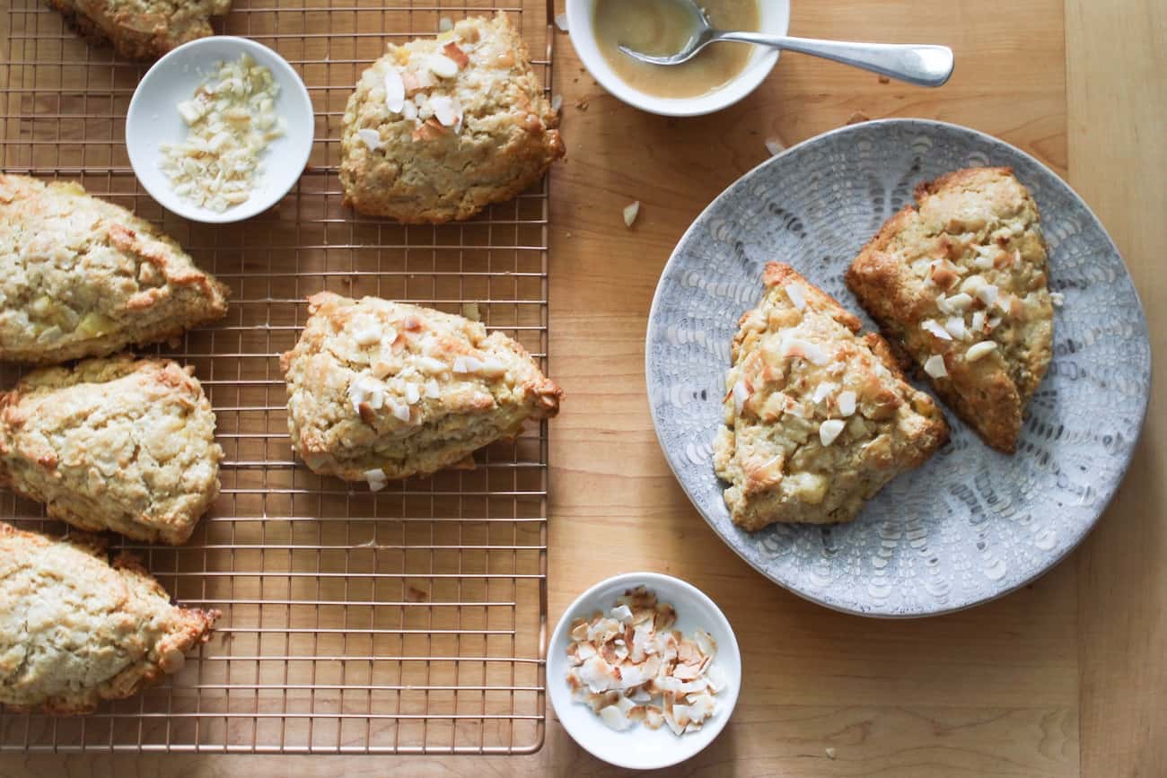 adding brown sugar glaze and garnishes to pineapple coconut scones