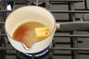 butter and maple syrup melting in saucepan