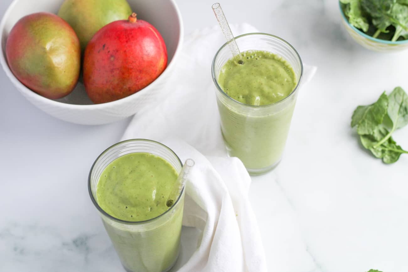 two tropical green smoothies on marble